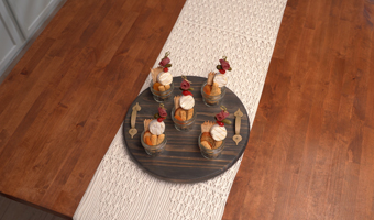 Round wood charcuterie board with jarcuterie arranged on it.